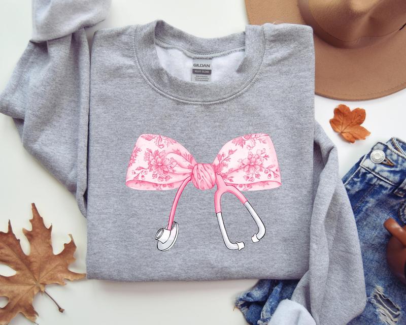 Pink Coquette Nurse Stethoscope Bow Sweatshirt, Gift for Nurse, Bow Oversized Shirt, Nurse Appreciation, Christmas Gift for Nurse, Pink Bow Sweater, G