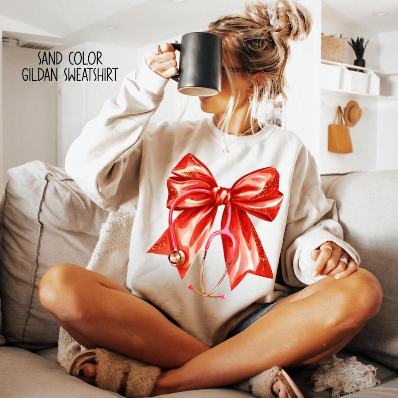 Coquette Nurse Stethoscope Bow Sweatshirt, Nurse Bow Shirt, Nurse Gift For Christmas, Coquette Nurse Shirt, Unisex Shirt, Gift For Her